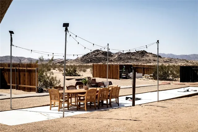 a patio outdoor space with patio fireplace and dining table
