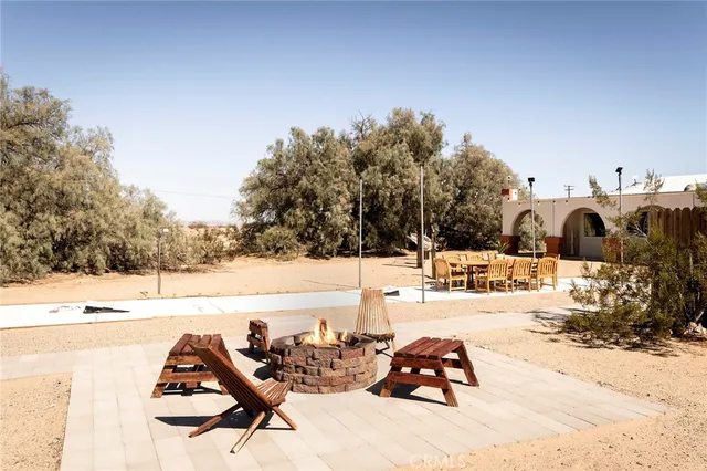 a front view of a house with glass top table and chairs