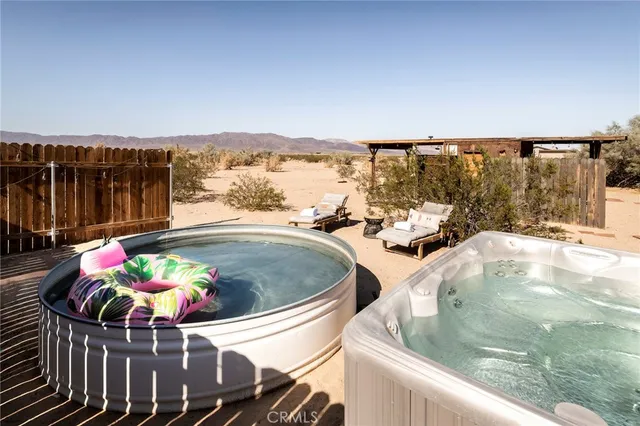 a view of a house with a yard and wooden fence