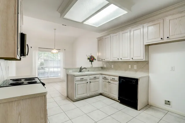 a kitchen with a sink and cabinets