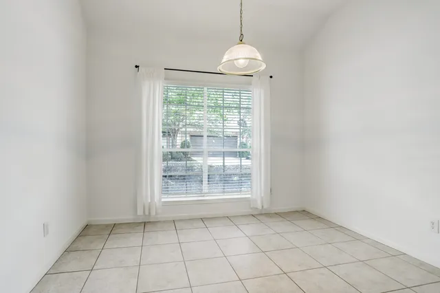 an empty room with a cabinet and mirrors