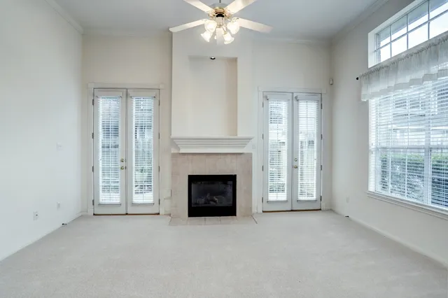 a view of a livingroom with a fireplace and large windows