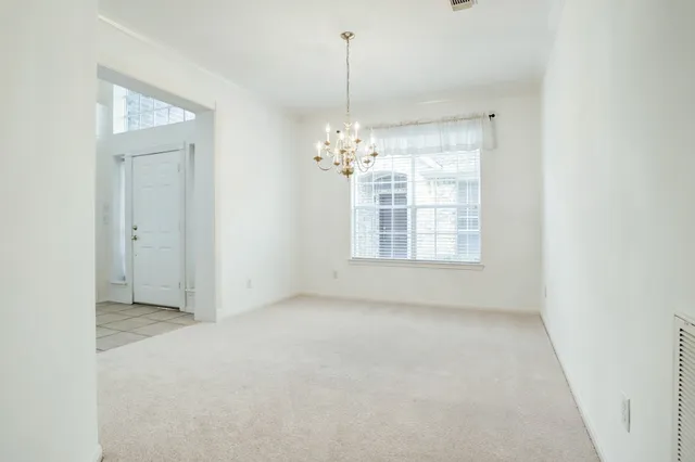 a view of a room with windows and chandelier