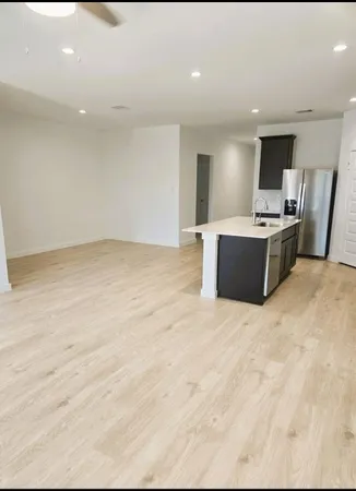 a view of kitchen and kitchen with stainless steel appliances