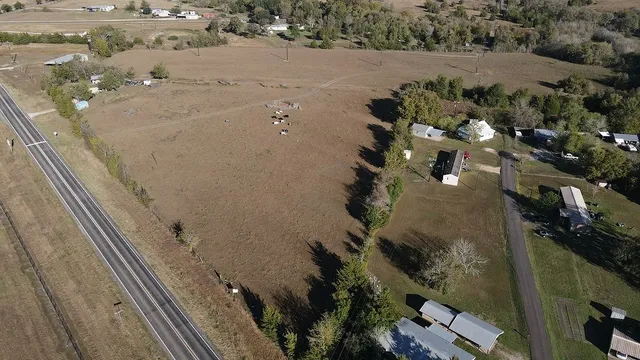 an aerial view of a house with a yard