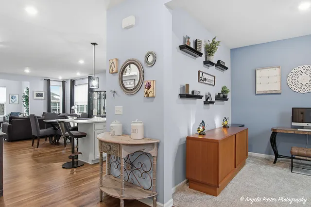a kitchen with a table chairs refrigerator and cabinets