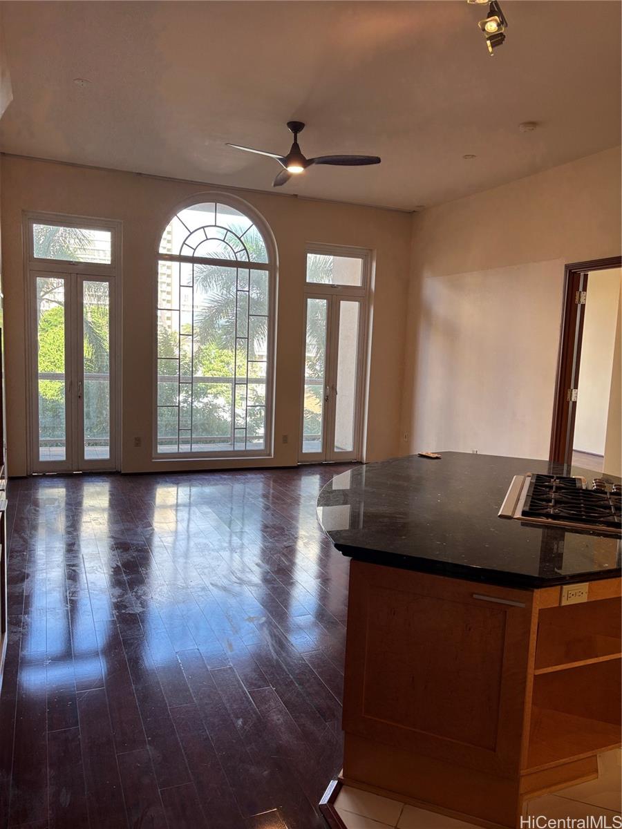 a view of a room with wooden floor and window