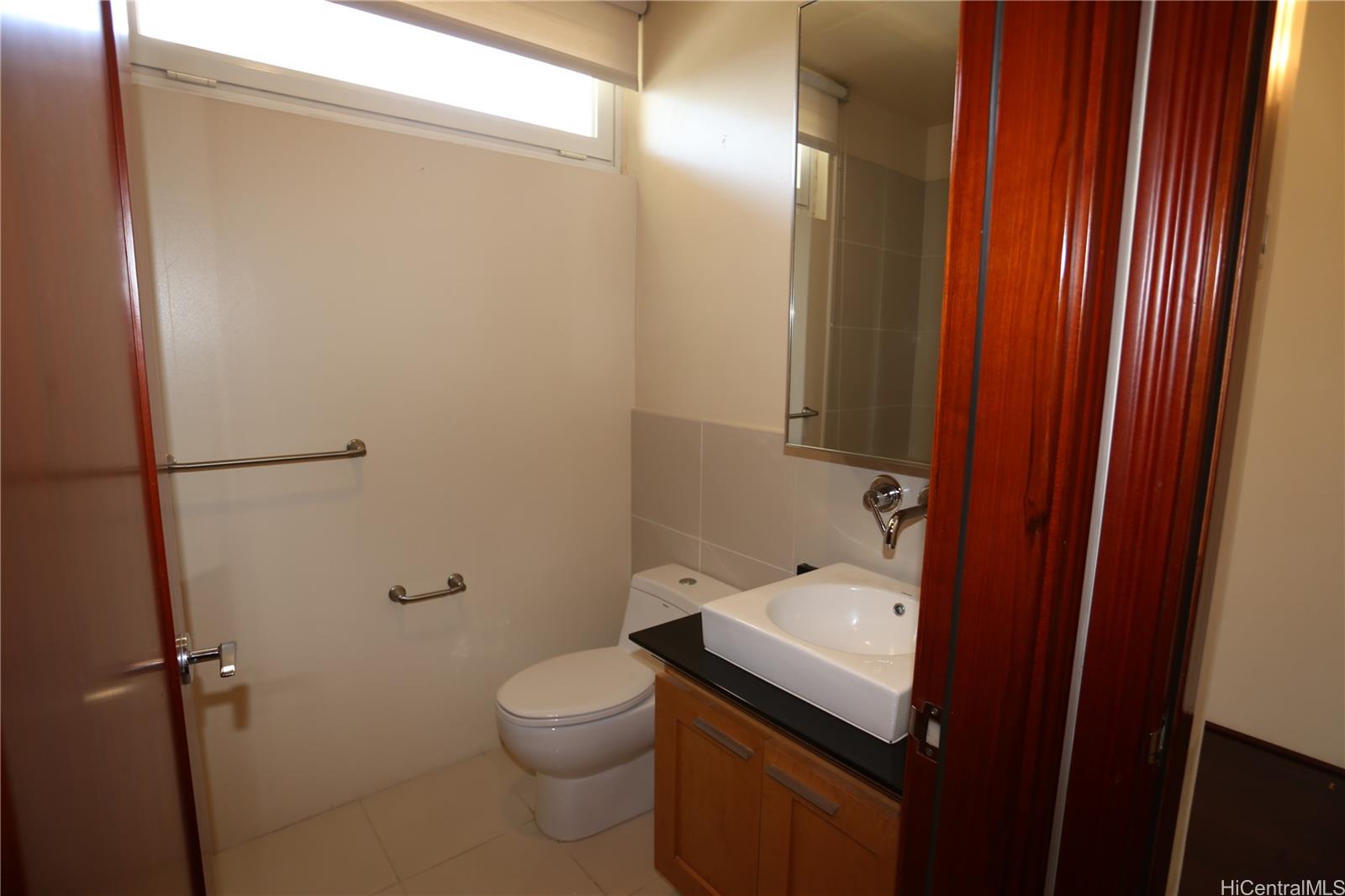 427 Launiu Street, Unit 403 Honolulu, HI 96815 - Photo 13 of 20 a bathroom with a sink a toilet and shower