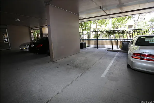 a view of garage with a car parked in it