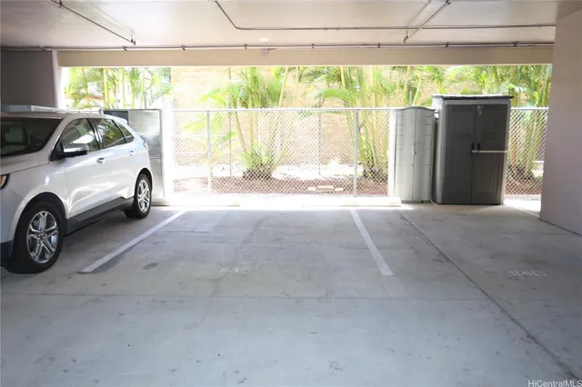 a view of car garage with a car parked