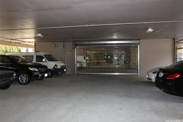 a view of garage with a car parked in it