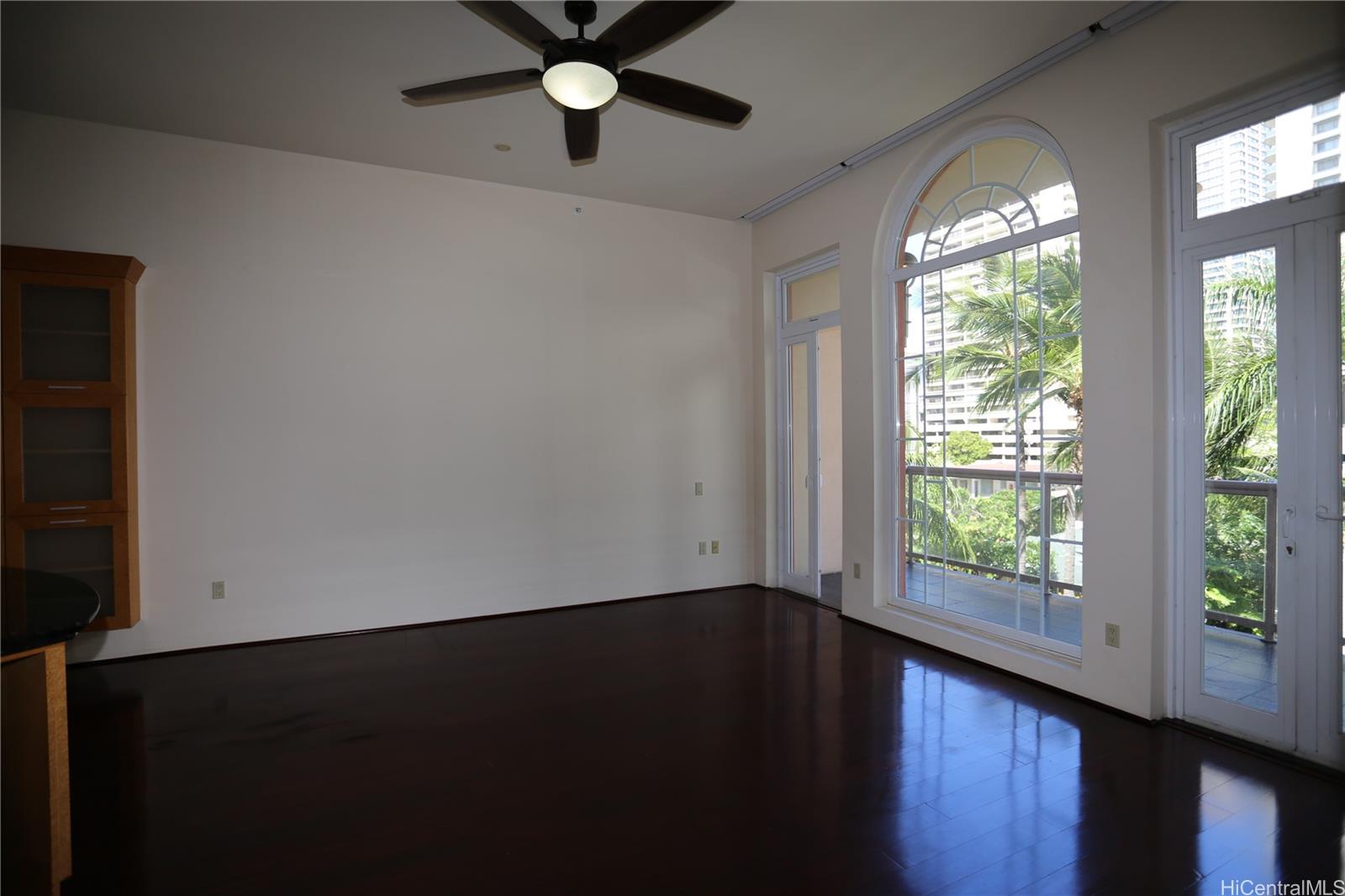 427 Launiu Street, Unit 403 Honolulu, HI 96815 - Photo 5 of 20 an empty room with wooden floor and windows
