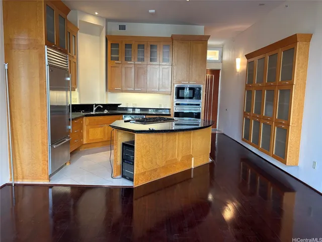 a kitchen with stainless steel appliances granite countertop a stove and a refrigerator