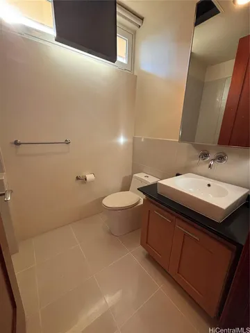 a bathroom with a sink a toilet and a mirror