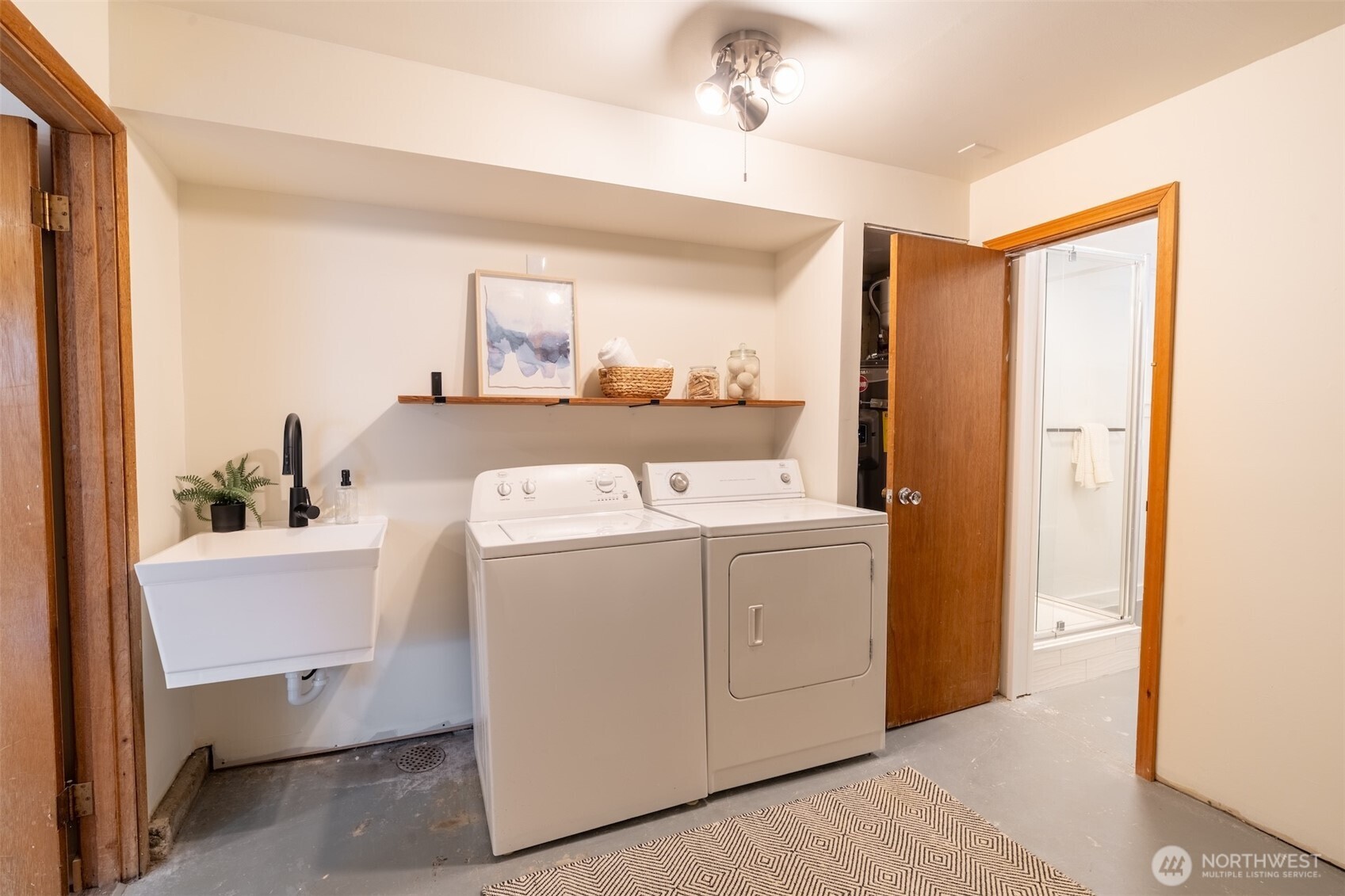1040 Northeast 154th Street Shoreline, WA 98155 - Photo 18 of 25 a view of washer and dryer with bathroom in the background