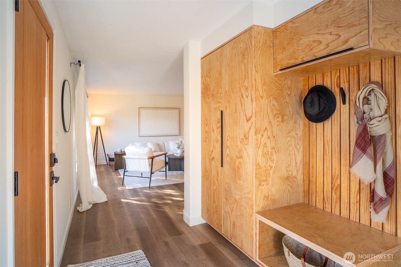 1040 Northeast 154th Street Shoreline, WA 98155 - Photo 2 of 25 a view of a hallway with wooden floor and a livingroom view