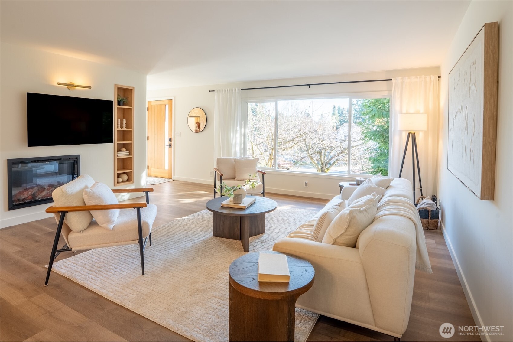 1040 Northeast 154th Street Shoreline, WA 98155 - Photo 4 of 25 a living room with furniture a flat screen tv and a floor to ceiling window