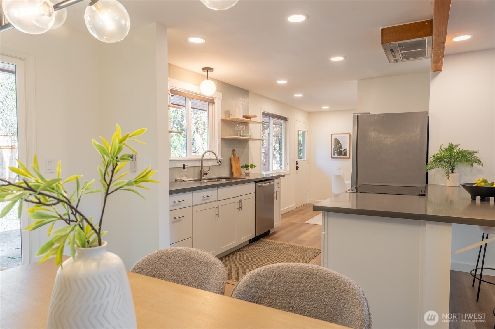 1040 Northeast 154th Street Shoreline, WA 98155 - Photo 7 of 25 a living room with stainless steel appliances furniture a potted plant and a large window