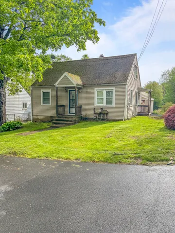 a front view of house with yard and green space