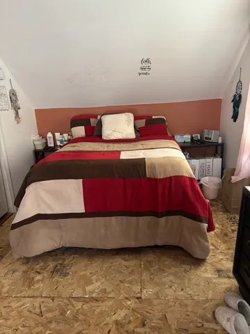 a bedroom with a bed and pillows