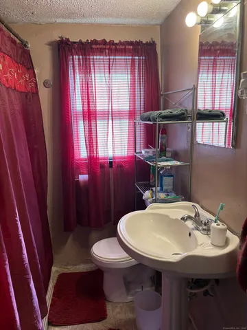 a bathroom with a sink a toilet and tub