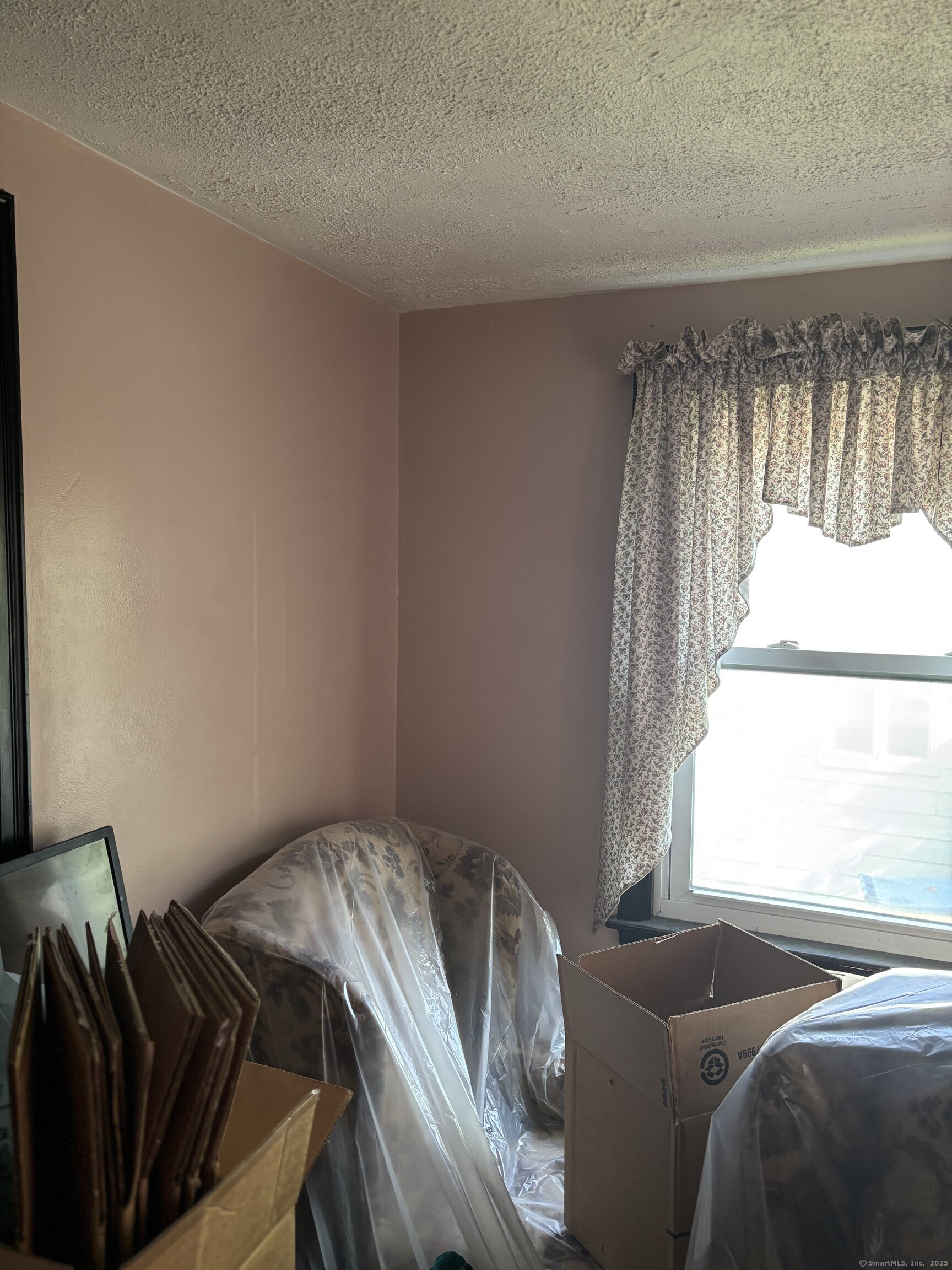 6 Peach Street Waterbury, CT 06708 - Photo 18 of 28 a bed sitting in a bedroom next to a window
