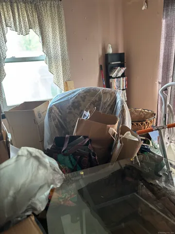 a bedroom with furniture and a window