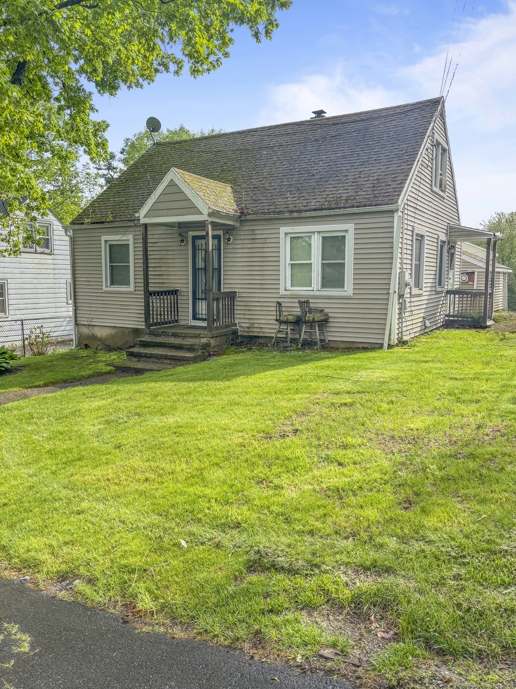 6 Peach Street Waterbury, CT 06708 - Photo 2 of 28 a front view of a house with a garden