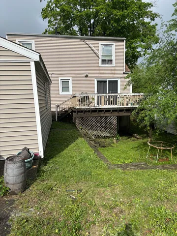 a view of a house with backyard and sitting area