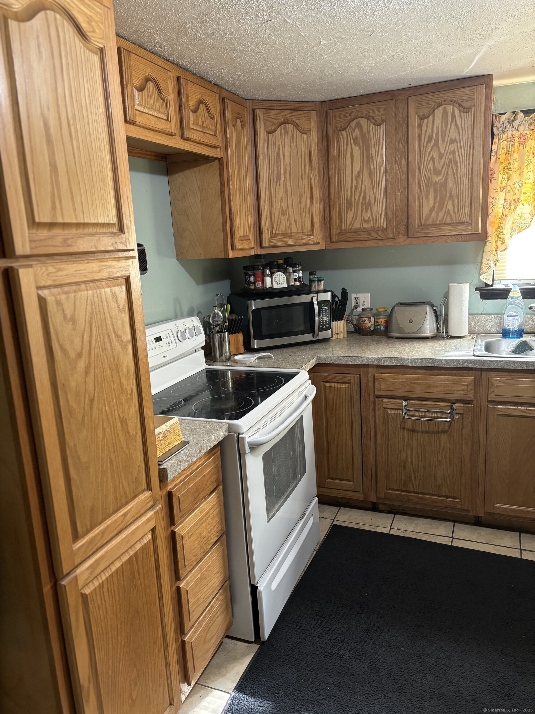 6 Peach Street Waterbury, CT 06708 - Photo 6 of 28 a kitchen with stainless steel appliances a refrigerator sink and cabinets