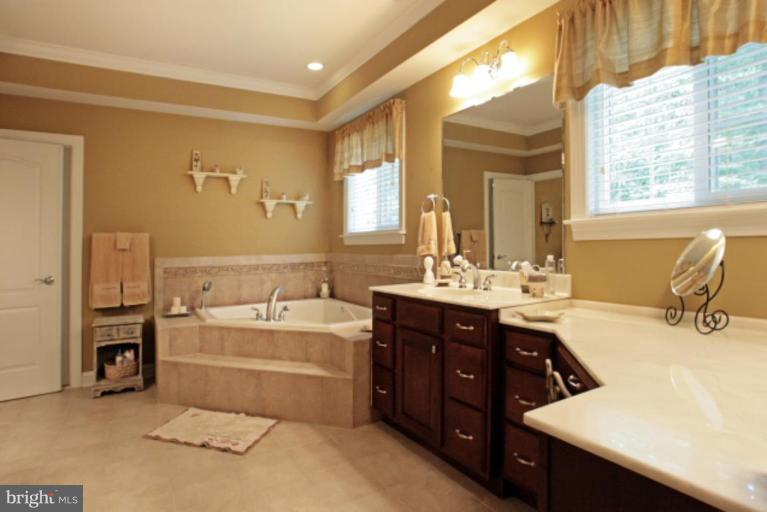 3744 Baker School House Road Manchester, MD 21102 - Photo 16 of 29 a bathroom with a tub sink and mirror