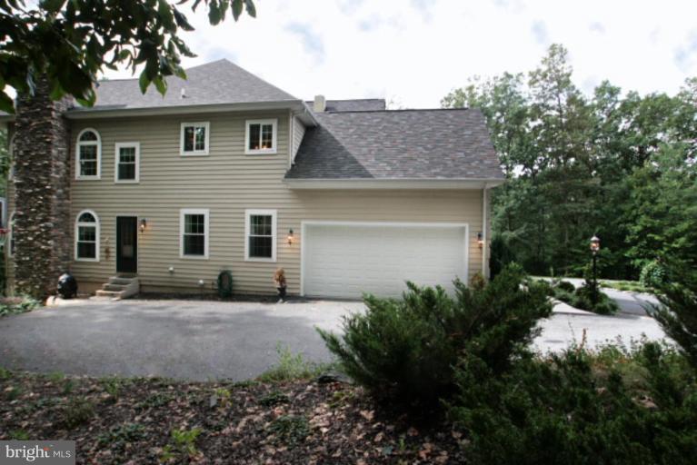 3744 Baker School House Road Manchester, MD 21102 - Photo 26 of 29 a front view of a house with a garden and tree