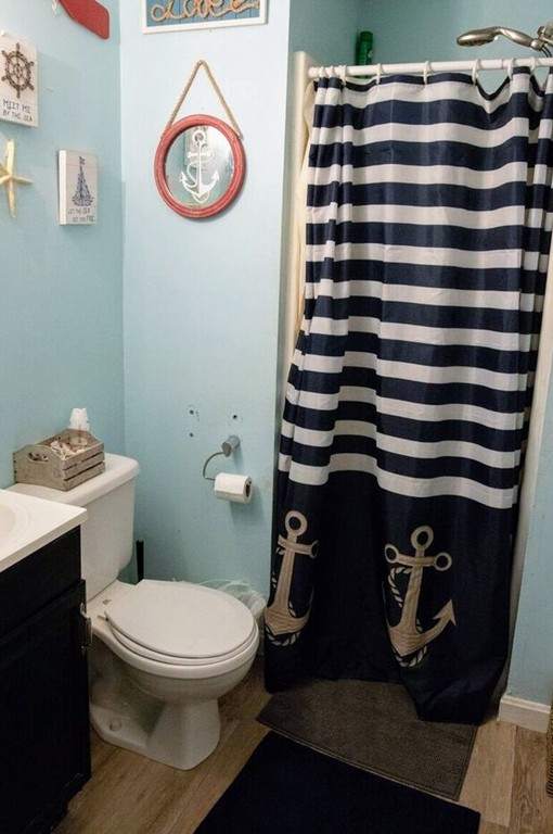 185 Smith Street Fall River, MA 02721 - Photo 6 of 16 a bathroom with a toilet and a mirror