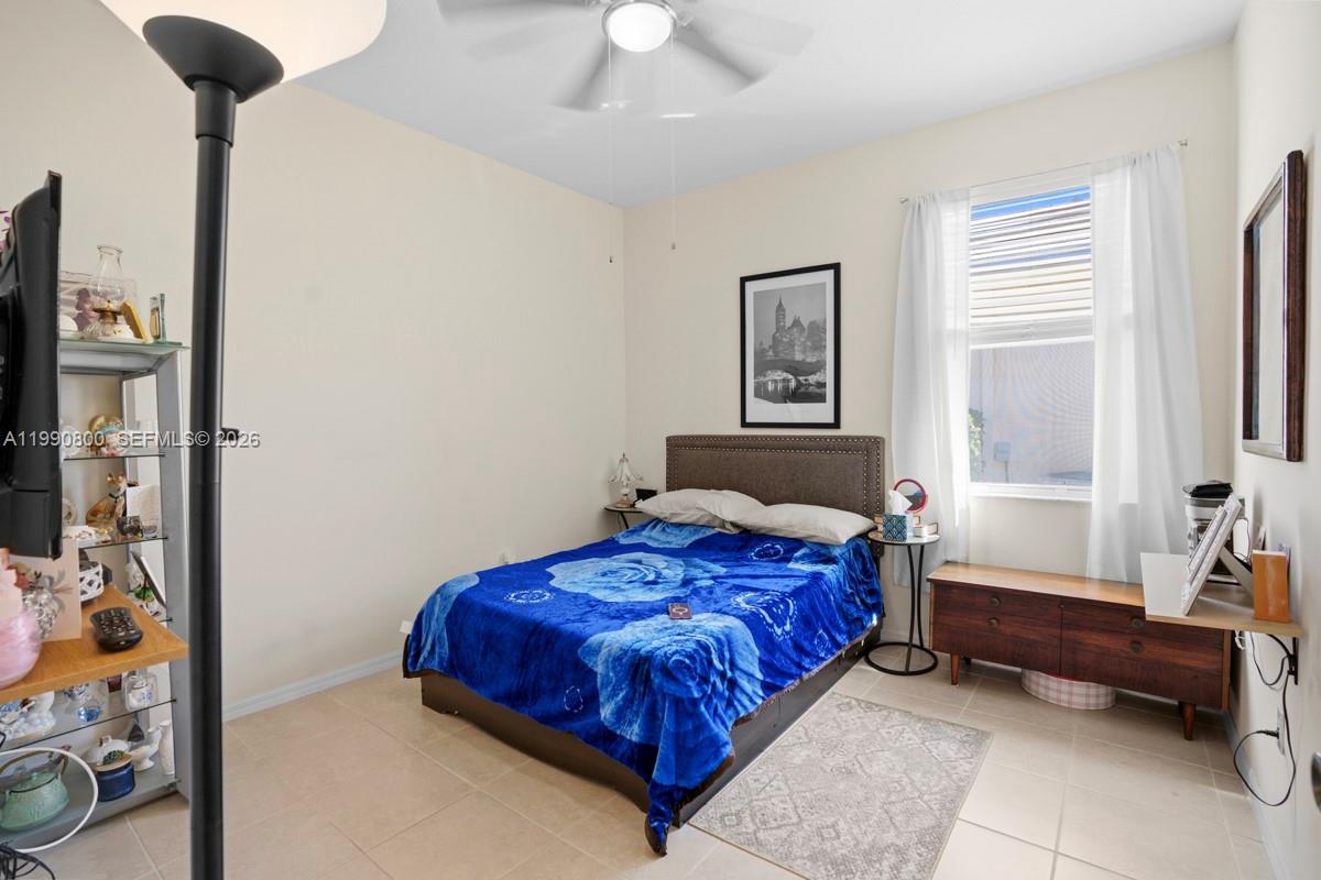 337 Southwest Maclay Way Port St. Lucie, FL 34986 - Photo 17 of 44 a bedroom with a bed and a chandelier