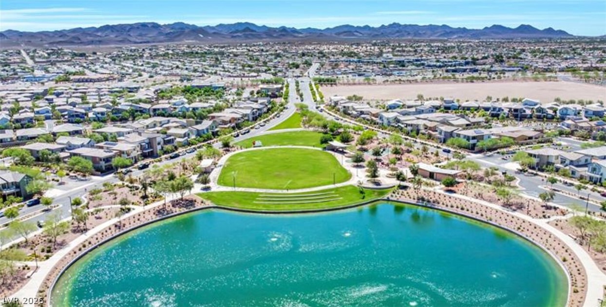 1100 East Sunset Road Henderson, NV 89011 - Photo 62 of 63 A scenic neighborhood park features a spacious green lawn bordering a calm blue pond.