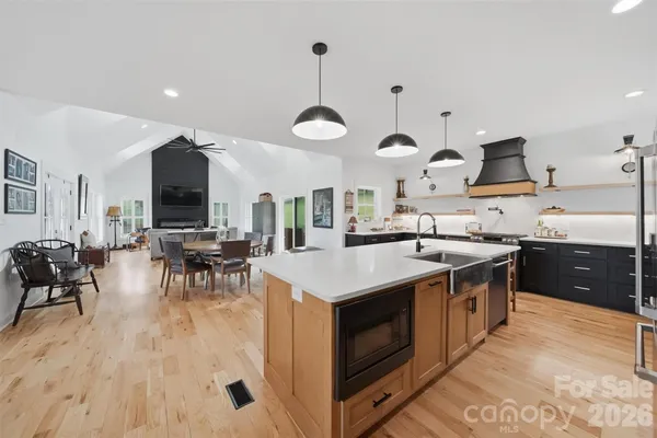 a kitchen with stainless steel appliances granite countertop a stove and cabinets