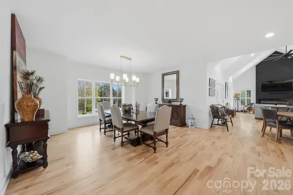a living room with furniture and a flat screen tv with wooden floor
