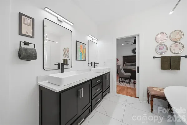 a bathroom with a sink a toilet and mirror