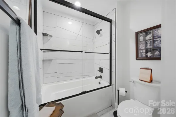 a bathroom with a shower and toilet