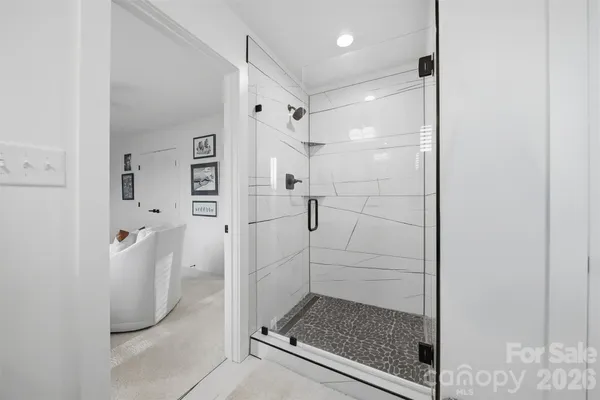 a bathroom with a glass shower door