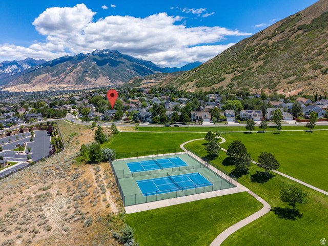 14883 Tooele Lane Draper, UT 84020 - Photo 12 of 49 Suburban setting featuring a community park with two tennis courts, expansive green space, and paved walking paths