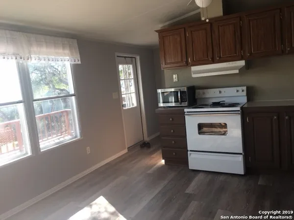 a kitchen with a stove and a window