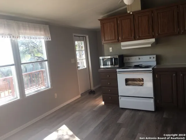 a kitchen with a stove and a window