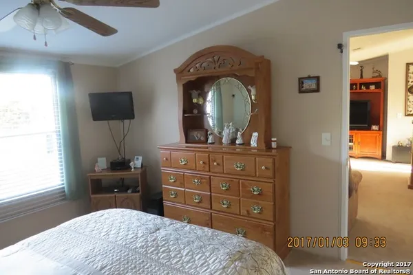 a bedroom with a bed and a dresser in it