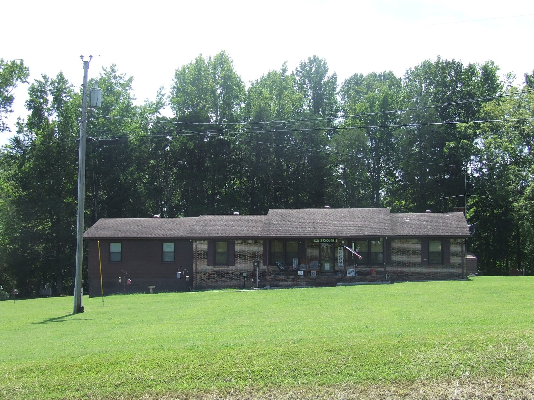 63 Sneed Road McMinnville, TN 37110 - Photo 2 of 22 a front view of a house with a yard and trees