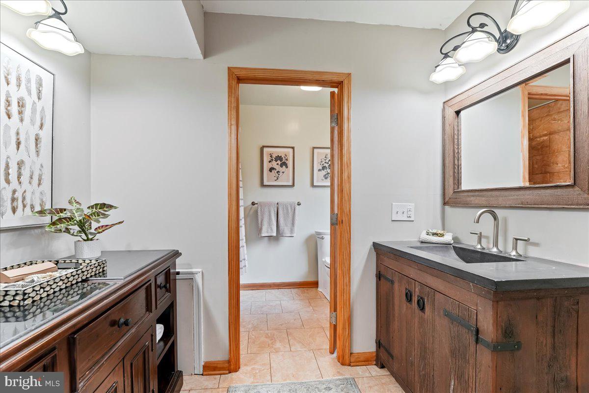 716 South Roberts Road Bryn Mawr, PA 19010 - Photo 26 of 39 a bathroom with a sink and a mirror
