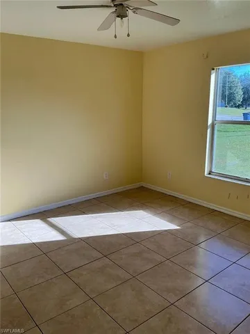 a view of a room with a window and a ceiling fan