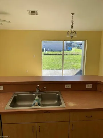 a kitchen with a sink and a window