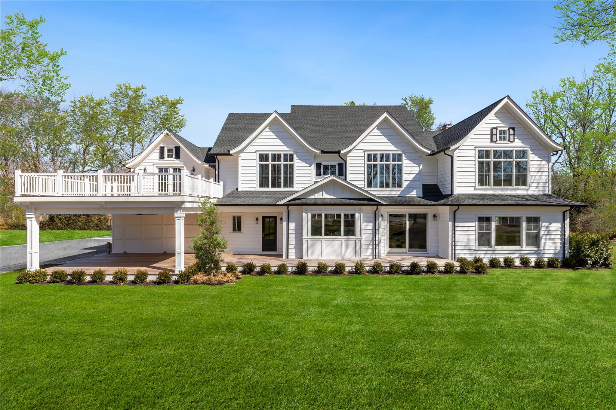 1132 Cedar Swamp Road Glen Head, NY 11545 - Photo 1 of 1 a front view of a house with a yard and trees