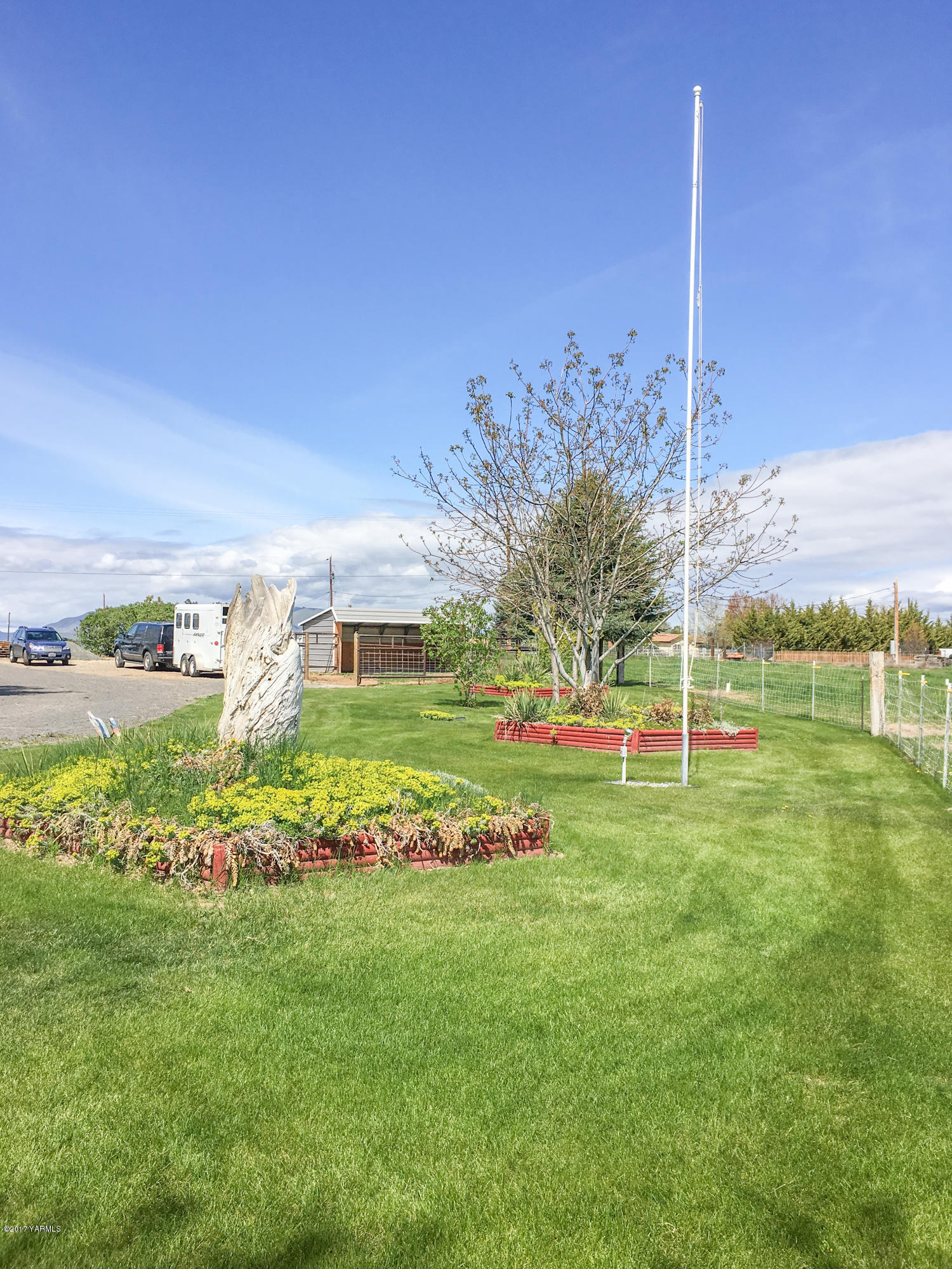 331 Sheep Company Road Selah, WA 98942 - Photo 28 of 40 a view of a house with a big yard and potted plants